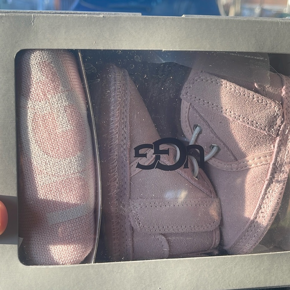Cute baby girl UGG booties. Size says 2/3. Never worn. Brand new